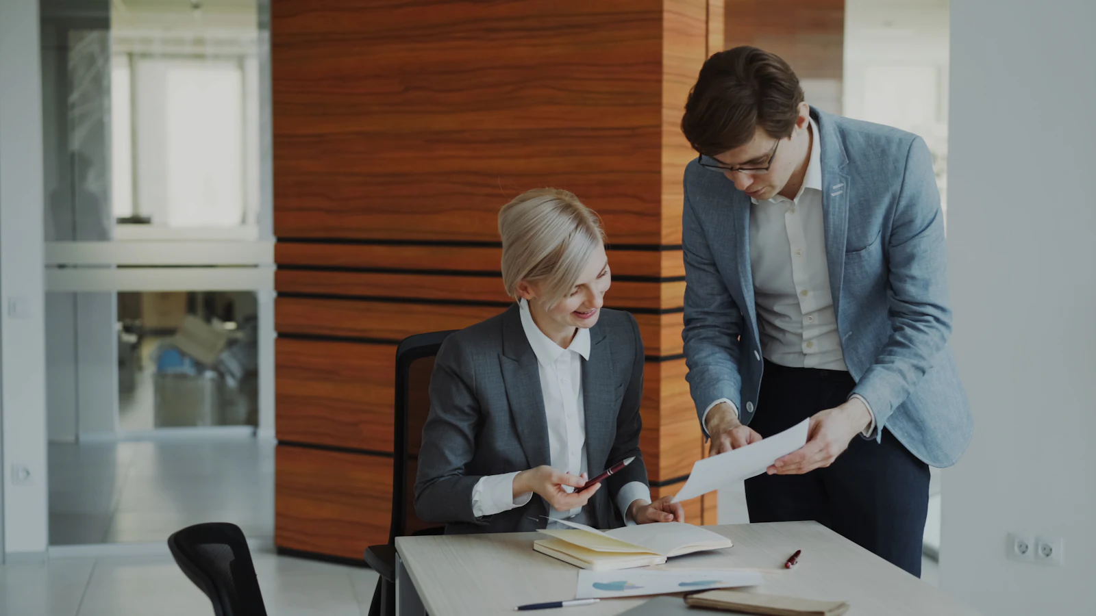 Two colleagues reviewing business documents